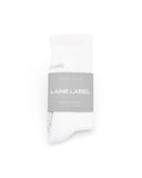 White socks with a gray label on a white background, featuring LAINE LABEL.